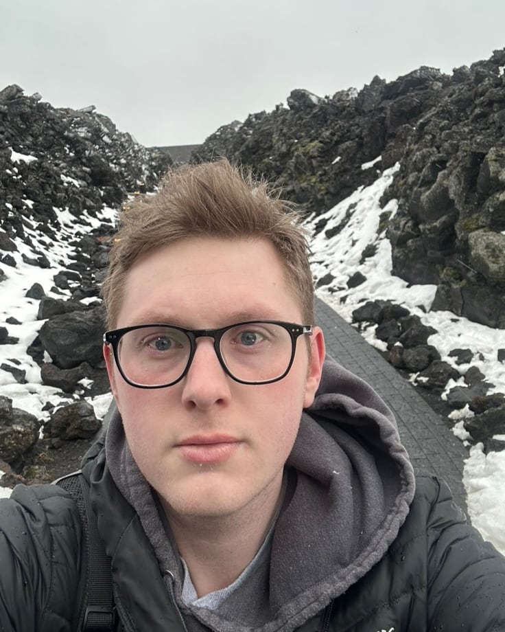 Spencer Nicolls on a path through a snowy lava field